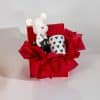 Valentine gift box with decorative love figurine and black heart pattern mug in elegant red romantic packaging on neutral background