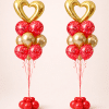 Pair of Valentine’s Day balloon columns with gold heart foil balloons, red and gold latex balloon clusters, and red balloon bases on a neutral background.