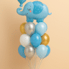 Balloon bouquet with a blue elephant foil balloon holding a "Baby Boy" balloon, surrounded by blue, white, silver, and gold latex balloons on a balloon base.