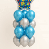Balloon bouquet featuring a large star-shaped foil balloon with a colorful “Happy Birthday” pattern, complemented by metallic blue and silver latex balloons arranged in a tiered display.