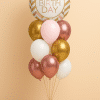 Balloon arrangement featuring a round “Happy Birthday” foil balloon in soft gold and blush pink, accompanied by an elegant mix of rose gold, gold, white, and blush pink latex balloons, tied with coordinated ribbons and arranged in a stylish tiered display.