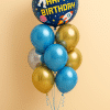Balloon bouquet with large navy blue “Happy Birthday” foil balloon featuring astronaut, rocket, and planets, surrounded by blue, gold, and silver latex balloons and matching balloon base.