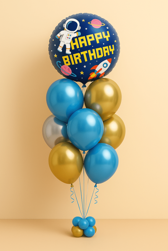 Balloon bouquet with large navy blue “Happy Birthday” foil balloon featuring astronaut, rocket, and planets, surrounded by blue, gold, and silver latex balloons and matching balloon base.