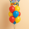 Balloon bouquet with colorful star-shaped foil balloon that reads “Happy Birthday” with a mix of red, yellow, and blue latex balloons on a matching balloon base.