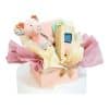 Baby gift box with piglet plush toy and natural rubber teether in a pastel pink box with pink and yellow tissue paper