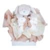 Neutral baby gift box with plush puppy and beige star blanket, arranged in soft tissue wrapping
