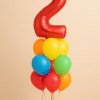 Red number 2 balloon surrounded by bright orange, yellow, green, blue, and red latex balloons.