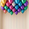 Loose assorted chrome latex balloons floating at the ceiling with long curling ribbons, creating a soft and playful party decor effect.