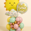 Pastel baby-themed balloon arrangement featuring a smiling sun, “Hello Baby” round foil balloon, and cloud with stars, on a base of mint, pink, yellow, lilac, and metallic balloons.