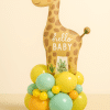 Baby giraffe-themed balloon arrangement with a “Hello Baby” foil topper and pastel base in yellow, mint green, orange, and mini accent balloons, perfect for baby showers or newborn gifts.