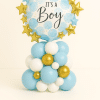 “It’s a Boy” balloon tower featuring a blue and white round foil balloon with golden and blue foil stars, set on a pastel blue, white, and gold latex balloon base — perfect for baby boy celebrations.