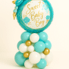 “Sweet Baby Boy” floral balloon tower in teal and gold, featuring a round foil topper with decorative flowers and a latex balloon base in teal, white, and gold — perfect for baby showers or newborn gifts.