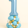 Balloon tower with large blue number 1 foil balloon on a base of light blue, white, and gold latex balloons — ideal for a baby boy’s first birthday celebration.