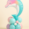 Pastel dolphin foil balloon with a soft-colored base in aqua, pink, lavender, and white — perfect for ocean, summer, or mermaid-themed birthday setups.