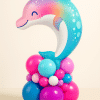 Rainbow pastel dolphin foil balloon on a vibrant base with hot pink, turquoise, purple, and white latex balloons — a fun and summery party decoration.