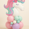 Pastel unicorn foil balloon with a golden horn standing on a soft base of pink, mint green, lilac, and cream balloons — perfect for magical birthday celebrations.