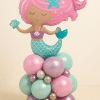 Mermaid foil balloon with pink hair and teal tail, standing on a shimmering pastel base of mint, pink, lavender, and silver balloons — perfect for under-the-sea themed celebrations.