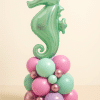 Mint green foil seahorse balloon atop a pastel balloon base in pink, mint, lavender, and chrome rose gold tones, perfect for under-the-sea themed parties.
