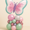 Balloon tower with large pastel butterfly foil balloon in pink, purple, and teal shades, on a mint and blush base with rose gold accents.