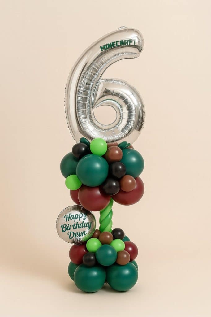 Balloon tower featuring a silver number “6” foil balloon with Minecraft branding, standing on a vibrant base of green, black, brown, and red balloons.