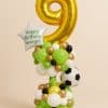 Balloon tower featuring a large gold number 9, football foil balloon, and green-white-gold balloon base with a custom birthday star message.