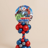 Balloon tower with superhero Happy Birthday foil balloon on a red, blue, and silver twisted balloon column and base.