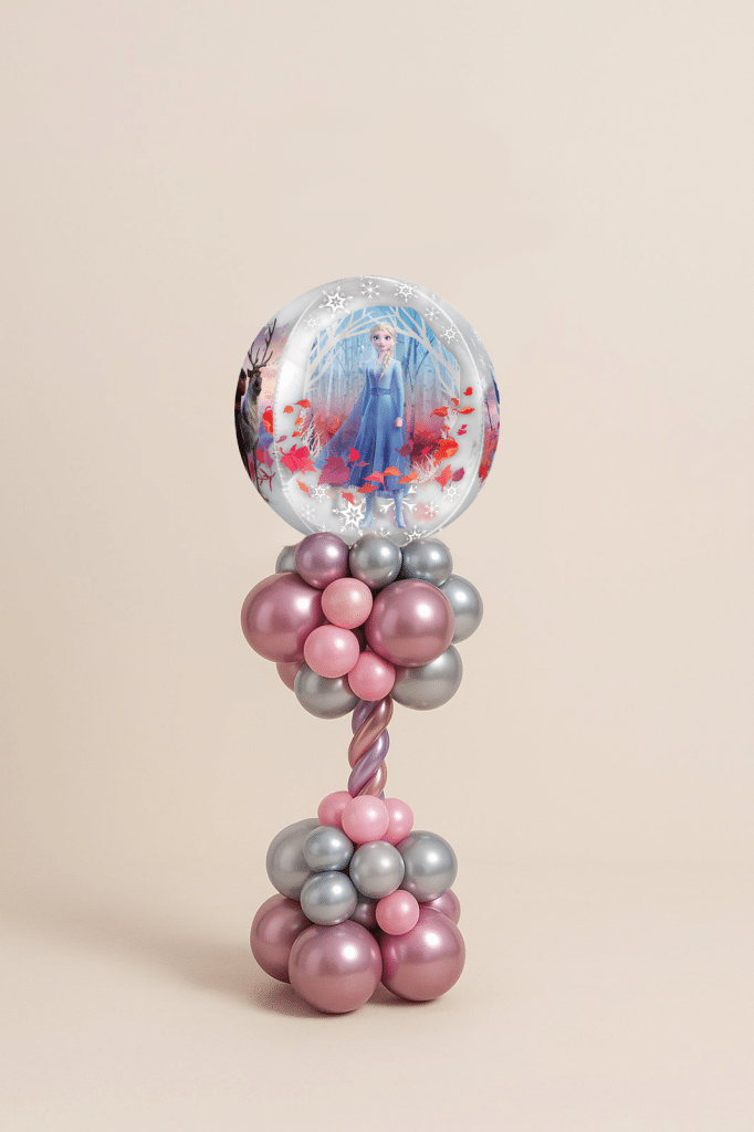 Frozen-themed balloon tower with Elsa bubble foil balloon, metallic pink and silver latex balloons in a twisted tower design with clustered base.