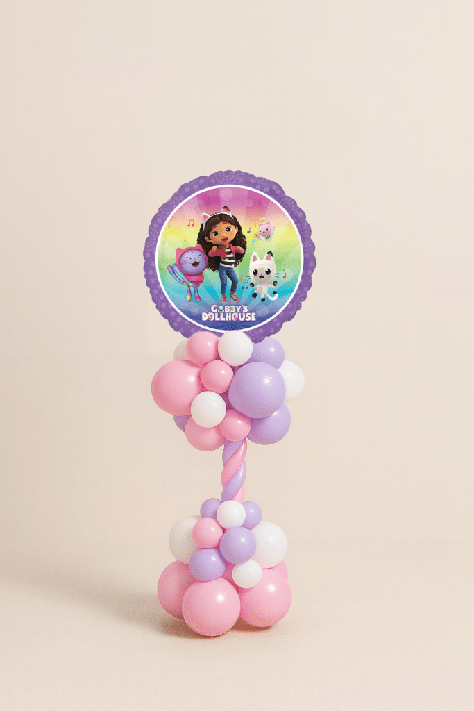 Gabby’s Dollhouse balloon tower with rainbow foil balloon featuring Gabby, Pandy Paws, and Cakey Cat, on a pink, lilac, and white spiral balloon base.