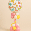 Get Well balloon tower with butterfly-themed foil balloon, decorated in pink, yellow, and white with spiral balloon stem.
