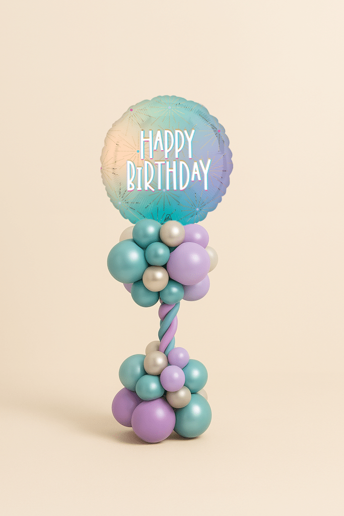 Birthday balloon tower with pastel Happy Birthday foil and twisted column in purple, turquoise, and silver.