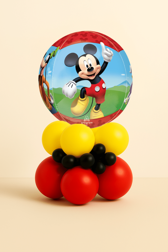 Mickey Mouse orb foil balloon table centerpiece with red yellow and black latex balloon base on neutral background