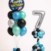 Space themed birthday balloon set with silver number tower and matching blue teal black and silver balloon bouquet with rocket design