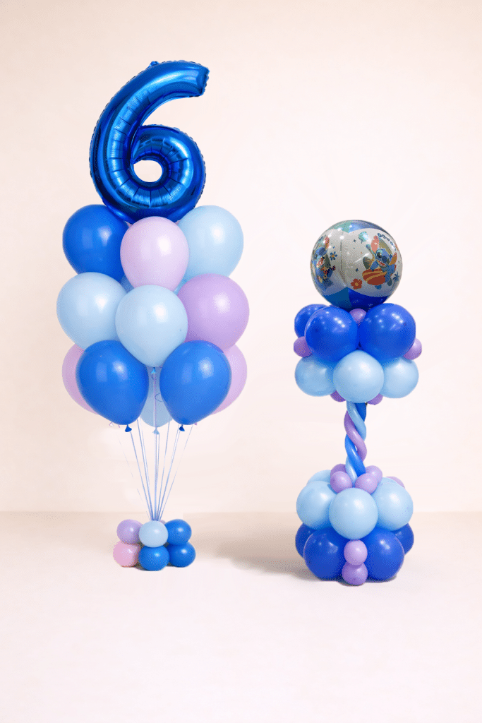 Blue and silver birthday balloon set with Stitch character column and custom silver number balloon on floor-standing bases