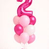 Pink birthday balloon bouquet with custom number foil balloon and matching pink and white latex balloons on a floor standing base