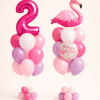 Pastel pink and lavender flamingo birthday balloon set with custom number balloon and matching Happy Birthday flamingo arrangement on floor standing bases