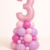 Pastel pink and lavender organic balloon number column with custom number topper and mixed-size balloon base for birthday decoration
