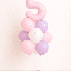Pastel pink and lavender number birthday balloon bouquet with white accents in soft elegant tones