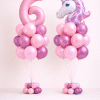 Pink unicorn birthday balloon duo with large number balloon and unicorn foil arrangement in blush and chrome magenta colours on matching small balloon bases
