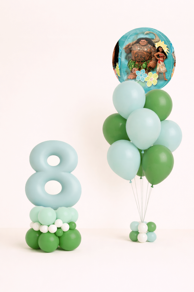 Moana and Maui birthday balloon duo with mint number 8 floor arrangement and tropical green latex bouquet in neutral studio background