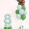 Moana and Maui tropical birthday balloon duo with mint number floor arrangement and matching green latex bouquet in neutral studio background