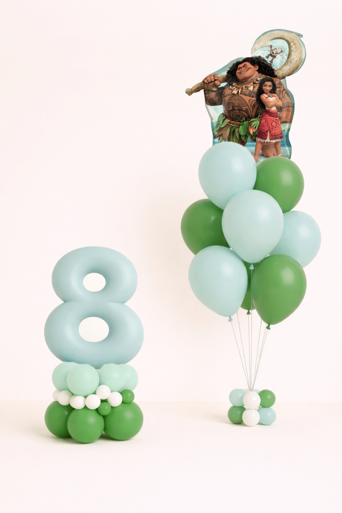 Moana and Maui tropical birthday balloon duo with mint number floor arrangement and matching green latex bouquet in neutral studio background