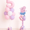 George Pig birthday balloon duo with pastel pink number helium bouquet and matching pink lavender twisted balloon column on neutral background