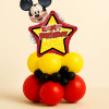 Mickey Mouse Happy Birthday star foil balloon table centerpiece with red yellow and black latex balloon base on neutral background