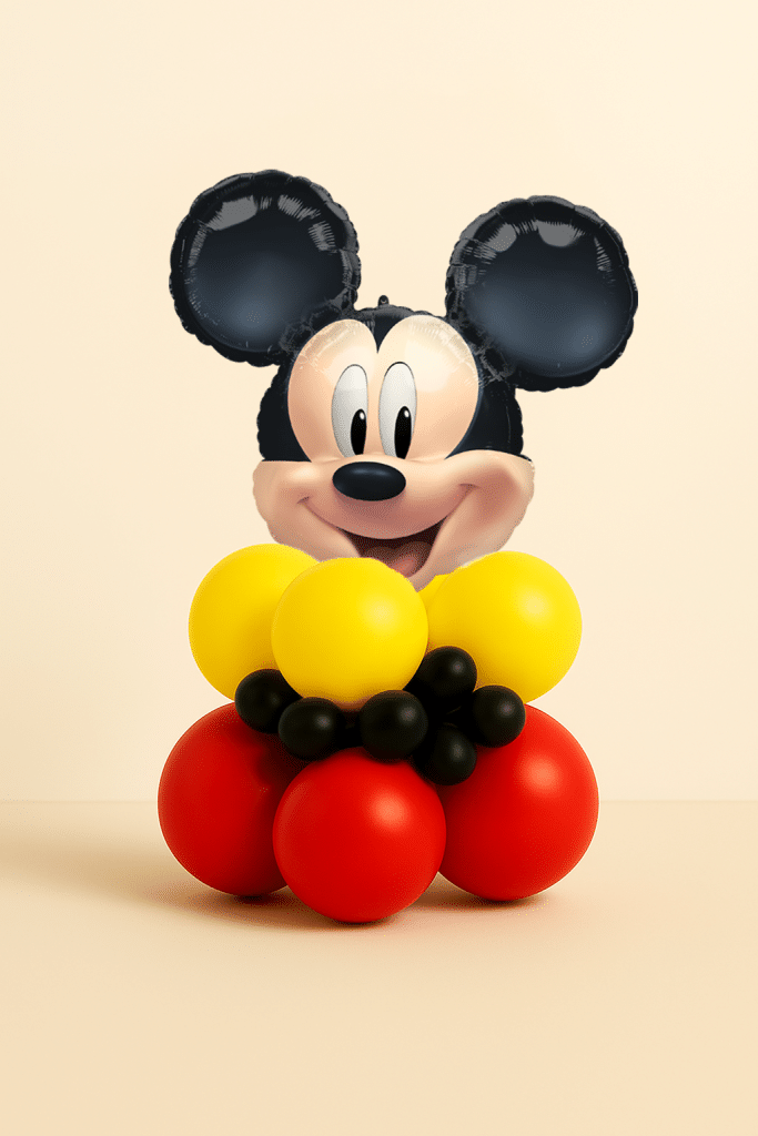 Mickey Mouse head foil balloon table centerpiece with red yellow and black balloon base on neutral background