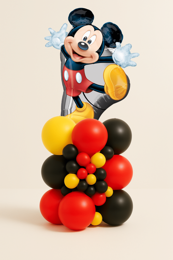 Mickey Mouse character balloon tower with red yellow and black latex balloon base and decorative mini balloon cluster.