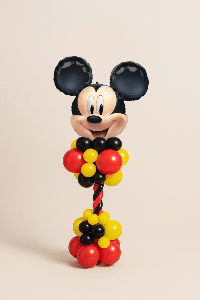 Mickey head foil balloon tower with red and black spiral column and red, yellow and black balloon base on a neutral background.