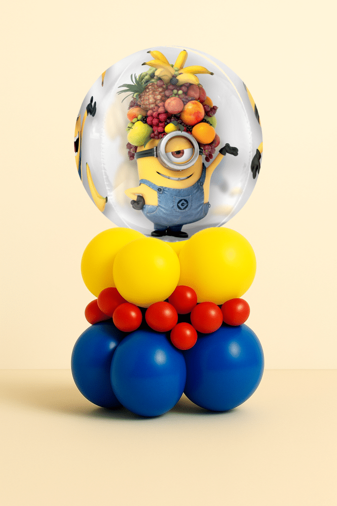 Minions bubble balloon table centerpiece with blue, yellow and red layered latex balloon base on a neutral background.