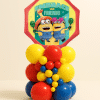 Minions Friends foil balloon table centerpiece with layered red, yellow and blue latex balloon base on a neutral background.