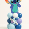 Stitch foil balloon topper on a pastel blue, lavender, and white organic balloon centerpiece on a neutral background.