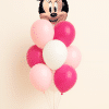 Minnie Mouse head foil balloon bouquet with pink and white helium latex balloons arranged on a decorative balloon base against a neutral background.